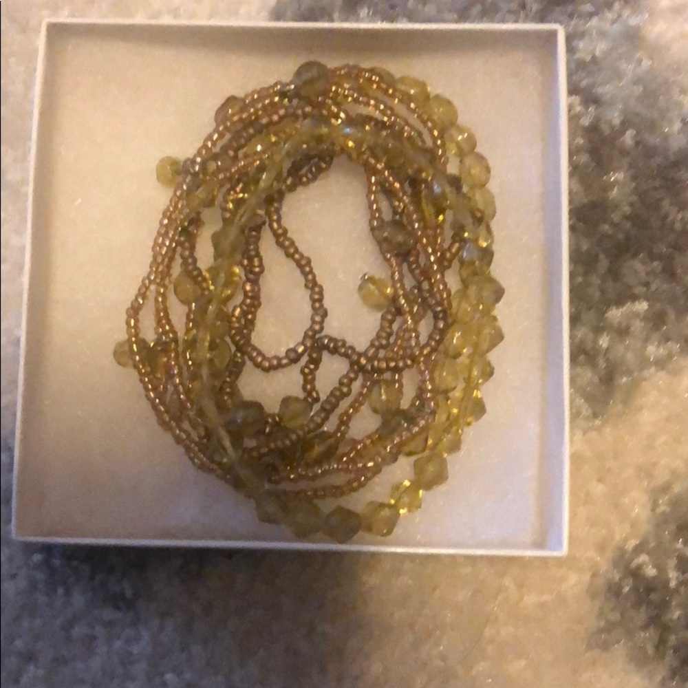 Nine orange and tan beaded bracelets